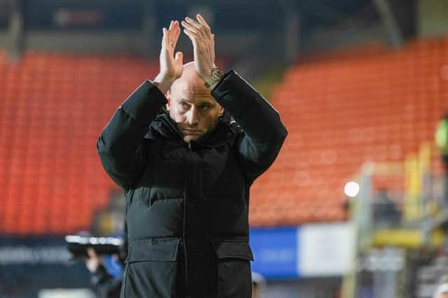 Hibs head coach David Gray applauds the travelling fans during the 3-1 win over Dundee United at Tannadice. (Photo by Ross Parker / SNS Group)