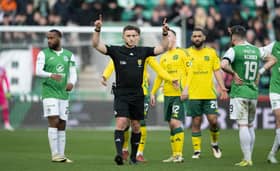 Referee Steven McLean confirms the VAR decision that the ball was out of play in the build up to Daizen Maeda's second goal for Celtic against Hibs at Easter Road. (Photo by Paul Devlin / SNS Group)