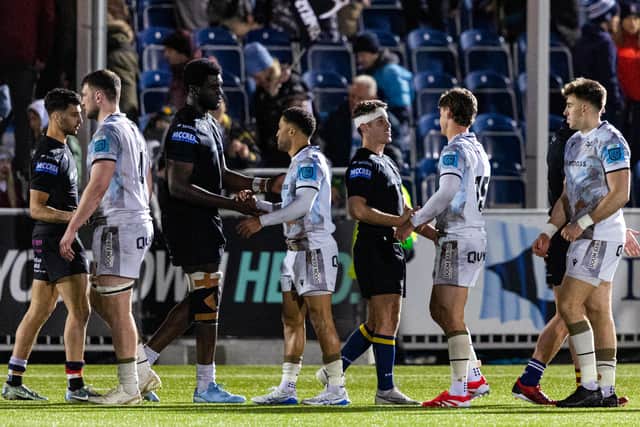 The teams shake hands at full time at Scotstoun.