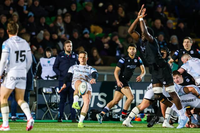 Glasgow Warriors' Jare Oguntibeju attempts to block Ospreys' Kieran Hardy's drop kick.