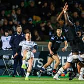 Glasgow Warriors' Jare Oguntibeju attempts to block Ospreys' Kieran Hardy's drop kick.