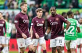 Hearts players Jamie McCart (L) and Elton Kabangu (R) look dejected at full-time after the 2-1 defeat to Hibs. (Photo by Mark Scates / SNS Group)