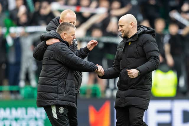 Hibs head coach David Gray leads reluctant assistant Eddie May - recently injured in a car crash - onto the pitch following the derby win over Hearts. (Photo by Mark Scates / SNS Group)