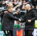Hibs head coach David Gray leads reluctant assistant Eddie May - recently injured in a car crash - onto the pitch following the derby win over Hearts. (Photo by Mark Scates / SNS Group)