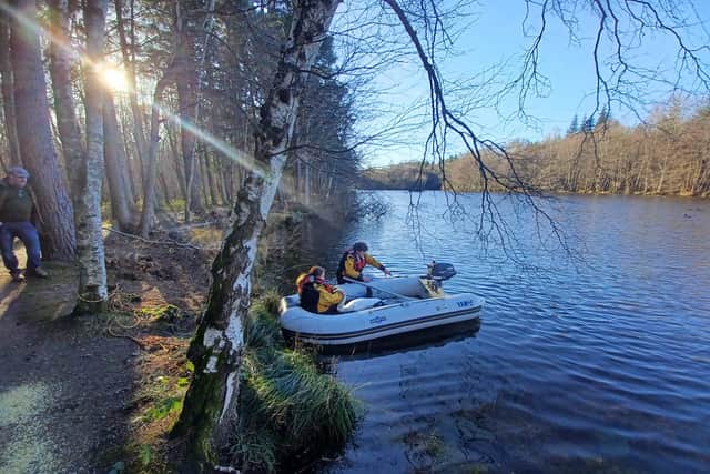 Scottish SPCA wildlife officers attempting to capture the injured swan
