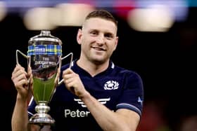 Finn Russell of Scotland poses for a photo with the Doddie Weir Cup following the teams victory in the Guinness Six Nations 2024 match between Wales and Scotland at Principality Stadium on February 3, 2024, in Cardiff. 