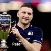 Finn Russell of Scotland poses for a photo with the Doddie Weir Cup following the teams victory in the Guinness Six Nations 2024 match between Wales and Scotland at Principality Stadium on February 3, 2024, in Cardiff. 