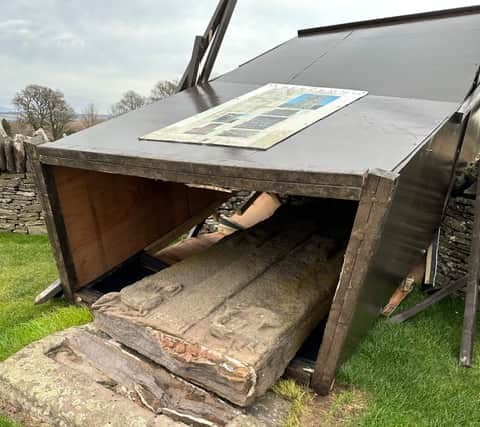 The fallen Aberlemno 3 surrounded by the protective box. Concerns had recently been raised about the stability of the structure.