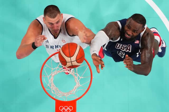 Nikola Jokic of Serbia and Lebron James of the US jostle for a rebound during an Olympic match at last year's games in France (pool picture)