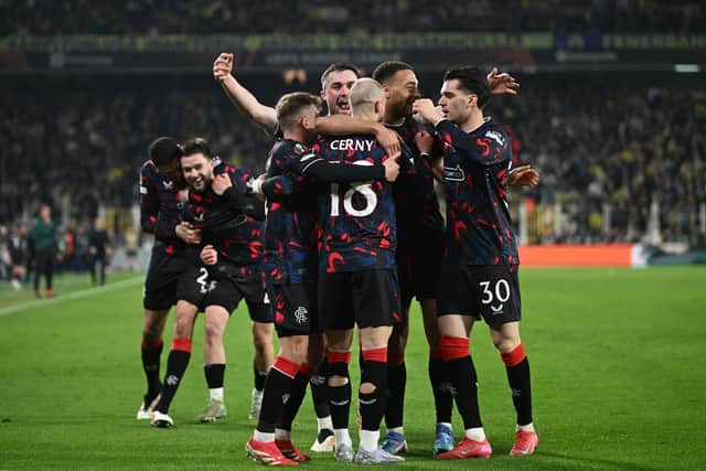The Rangers players celebrate in front of their supporters.