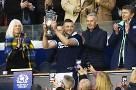 Finn Russell lifts the Doddie Weir Cup after Scotland's Six Nations win over Wales.