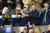 Finn Russell lifts the Doddie Weir Cup after Scotland's Six Nations win over Wales.