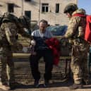 Ukrainian army medics provide first aid to a man at the scene of a Russian Iskander missile attack on a residential building in Kharkiv, Ukraine on Friday (Picture: Diego Fedele)