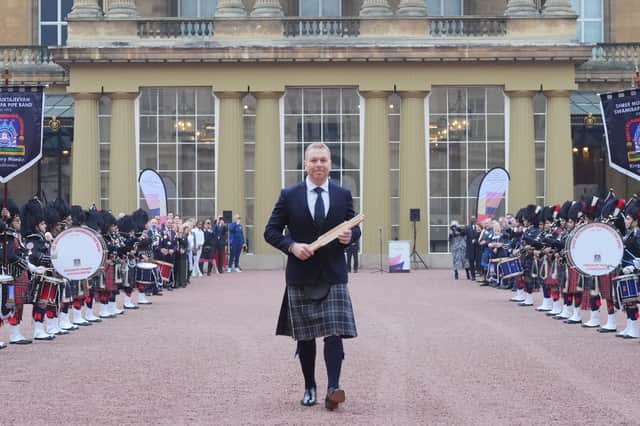 Sir Chris Hoy holding the Commonwealth baton at the launch of the Commonwealth Sport King's Baton Relay, officially starting the countdown towards the Glasgow 2026 Commonwealth Games at Buckingham Palace, London