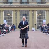 Sir Chris Hoy holding the Commonwealth baton at the launch of the Commonwealth Sport King's Baton Relay, officially starting the countdown towards the Glasgow 2026 Commonwealth Games at Buckingham Palace, London