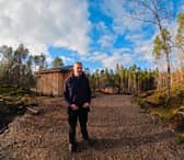 Tom Cooper, of Glengarry Community Development Trust, with the cabins set in the woods.