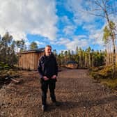 Tom Cooper, of Glengarry Community Development Trust, with the cabins set in the woods.