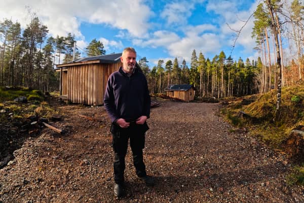 Tom Cooper, of Glengarry Community Development Trust, with the cabins set in the woods.