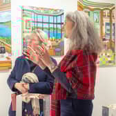 Virginie Barrou Planquart from Galerie Barrou Planquart in Paris, discussing her artists' work with a visitor to Edinburgh Art Fair