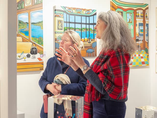 Virginie Barrou Planquart from Galerie Barrou Planquart in Paris, discussing her artists' work with a visitor to Edinburgh Art Fair