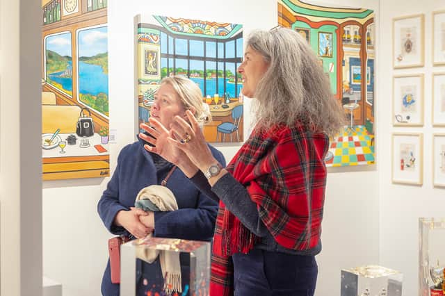 Virginie Barrou Planquart from Galerie Barrou Planquart in Paris, discussing her artists' work with a visitor to Edinburgh Art Fair