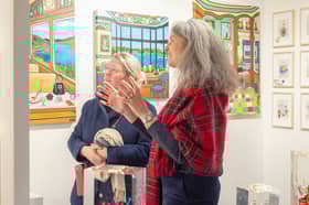 Virginie Barrou Planquart from Galerie Barrou Planquart in Paris, discussing her artists' work with a visitor to Edinburgh Art Fair