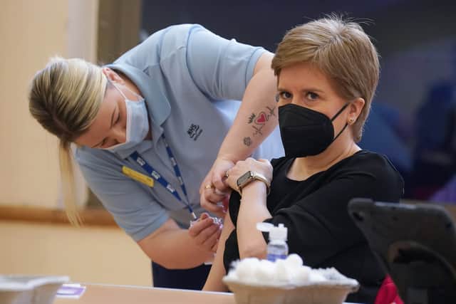 Nicola Sturgeon receives a Covid booster jab and a separate flu jab from healthcare support worker vaccinator Helen Macleod at Glasgow Central Mosque in November 2022.