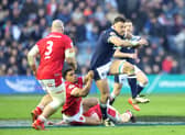 Scotland's Jack Dempsey is tackled by Wales' Ben Thomas during the Guinness Six Nations match at Murrayfield.