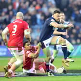 Scotland's Jack Dempsey is tackled by Wales' Ben Thomas during the Guinness Six Nations match at Murrayfield.