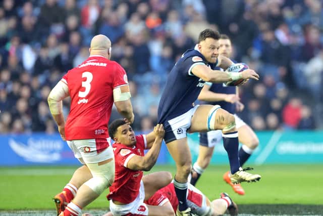 Scotland's Jack Dempsey is tackled by Wales' Ben Thomas during the Guinness Six Nations match at Murrayfield.