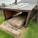 The fallen Aberlemno III stone surrounded by its protective box