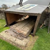 The fallen Aberlemno III stone surrounded by its protective box