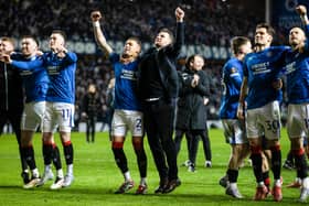 Rangers interim head coach Barry Ferguson celebrates with James Tavernier in front of the fans.