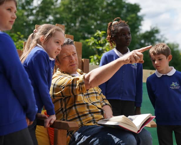 Jamie Oliver reads extracts from his book, Billy and the Epic Escape, during a visit to a  school in Essex
