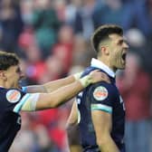 Scotland's Blair Kinghorn celebrates scoring a try against Wales.