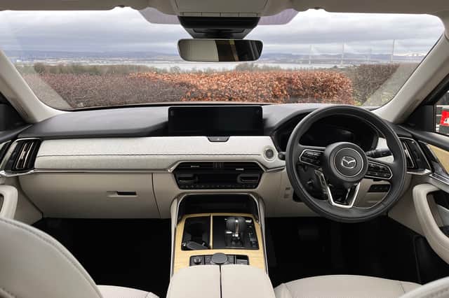 The plush interior of the Mazda CX-80 holds up well against premium competitors. Forth Bridges in the background.