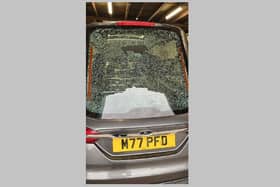 The smashed window of the hearse