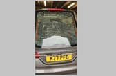 The smashed window of the hearse