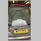 The smashed window of the hearse
