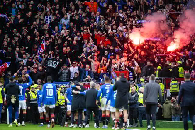 Rangers fans light pyrotechnics as they celebrate with the team at full time after the 3-2 win at Celtic Park.  (Photo by Paul Devlin / SNS Group)