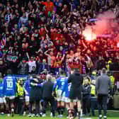 Rangers fans light pyrotechnics as they celebrate with the team at full time after the 3-2 win at Celtic Park.  (Photo by Paul Devlin / SNS Group)