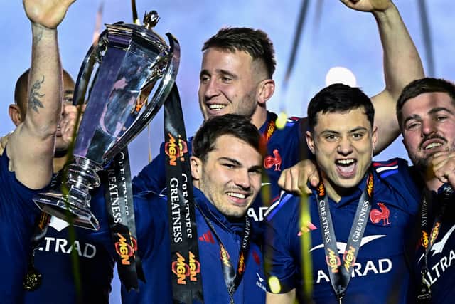 France's injured captain Antoine Dupont with the Six Nations trophy alongside top try-scorer Louis Bielle-Biarrey.