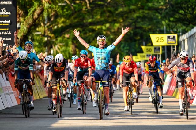 Britain's Mark Cavendish (centre) celebrates as he crosses the finish line during the third Tour de France Singapore Criterium race in Singapore. The Tour de France will start from Edinburgh in 2027.