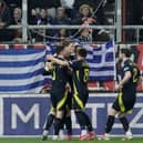 Scotland's Scott McTominay celebrates with teammates after scoring the opening goal during the Nations League play off first leg game against Greece. Cr: AP