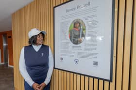 Dr Renee Powell looks at the newly-unveiled plaque in Powell Hall student residence in St Andrews