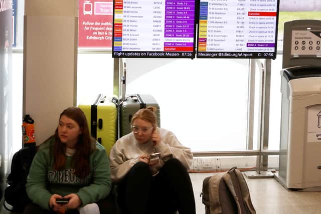 Malarie and Maranda from Oklahoma wait at Edinburgh airport after the closure of Heathrow has thrown the country into travel chaos, March 21 2025.
