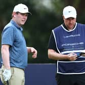 Bob MacIntyre talks tactics with caddie Mike Burrown during the second round of the Porsche Singapore Classic at Laguna National Golf Resort Club  