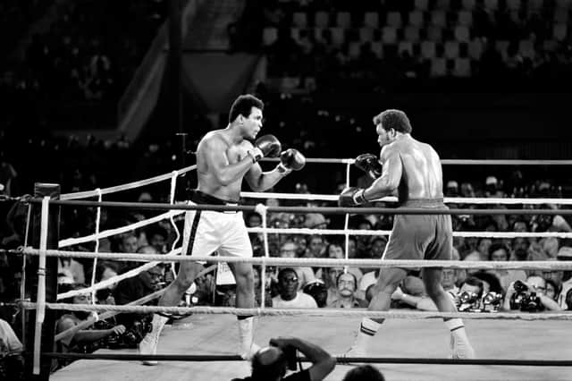 Former world heavyweight champion Muhammad Ali (L) and titleholder US George Foreman (R) fight on October 30, 1974 in Kinshasa, Zaire during their world heavyweight championship match. Ali won by knocking out Foreman in the eighth round. PIC: AFP via Getty Images.
