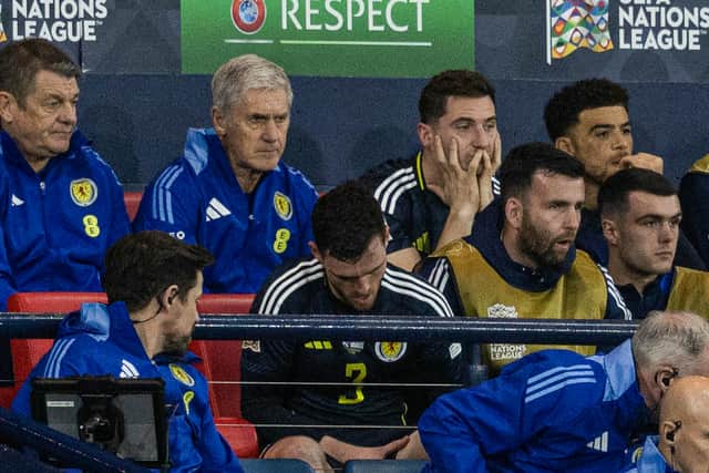 Scotland's Andy Robertson and Kenny McLean look dejected as they watch on from the bench in the 3-0 defeat to Greece.