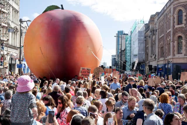 As part of a celebration of Cardiff-born author Roald Dahl, a giant peach makes its way through the streets of the city (Picture: Matt Cardy)